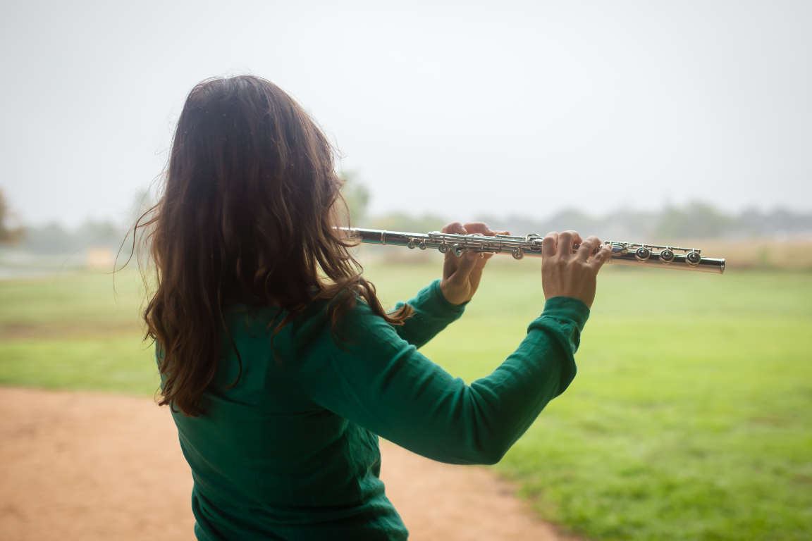 Sarah playing the flute outdoors